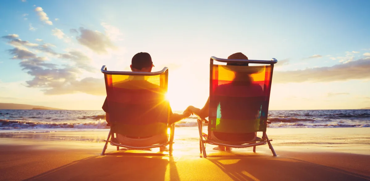 seniors on beach chairs at sunset